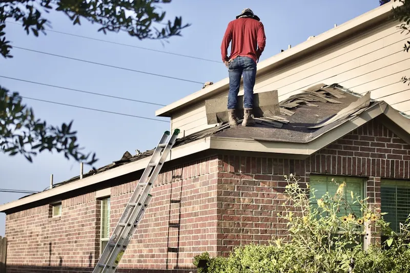Professional roofer working on a residential roof in Delawanna